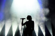 © nagaets - Vocalist singing to microphone. Singer in silhouette