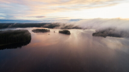 Wall Mural - Beautiful sunrise on a foggy forest lake. Early morning with mist above the lake and forest. Drone shot.