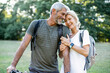 © PhotoAlto - Smiling mature couple standing in forest