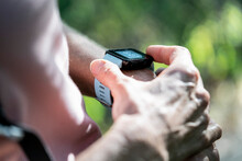 Close-up Of Mature Woman's Hands Checking Time On Smart Watch