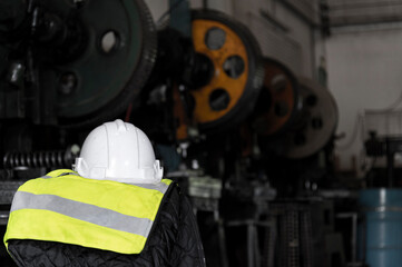 protect safety helmet and safety Vest put on engineering machine in industrial factory