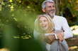 © PhotoAlto - Happy mature couple embracing each other in backyard