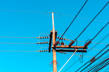 Electricity pole against blue sky clouds, Transmission line of electricity to rural distribution