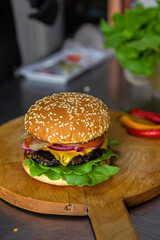 Sticker - Fresh and delicious big burger served on a wooden board in a cafe