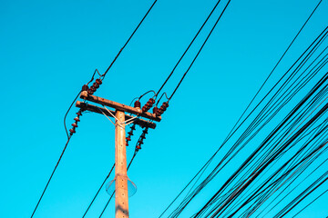 Electricity pole against blue sky clouds, Transmission line of electricity to rural distribution