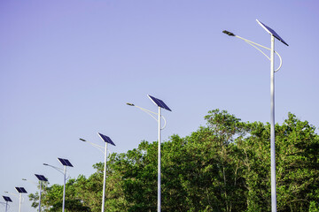 Wall Mural - solar cell lamp electricity system for alternative power energy on street with green tree nature, fu