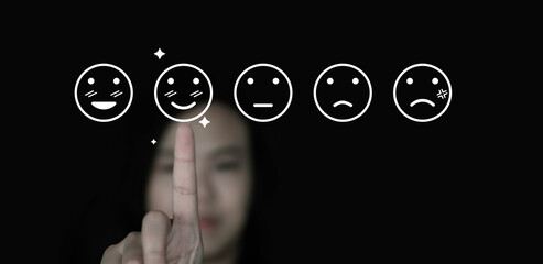 Wall Mural - world mental health day concept or feedback rating and positive customer review, Business woman hand choose smile face icon, emotion of happiness and sadness face icon on dark background	