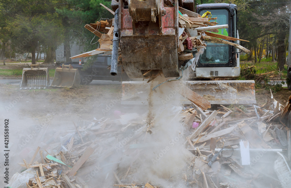 Destroying House Demolition of wooden house in trash debris outside of neighborhoods ...