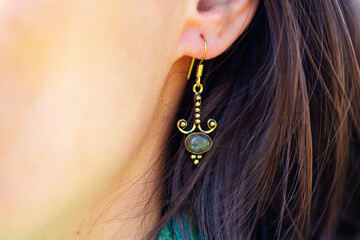 Wall Mural - Detail of female ear wearing stone mineral floral shape bead earring