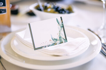 Elegant modern invitation card template with the inscription of the guest lies on a white plate.