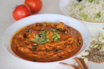 Sticker - Cottage cheese cubes in a rich smooth gravy of tomatoes, cashew nuts, spices served with Steamed basmati rice flavoured with Cumin and spices.