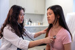© Lynsey Weatherspoon/Creative Flame - Asian doctor checks patient heartbeat using stethoscope