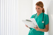 © Tetra Images/Tetra Images - Healthcare worker looking at medical chart