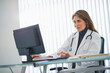 © Tetra Images/Tetra Images - USA, New Jersey, Jersey City, Female doctor using computer in office