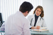 © Tetra Images/Tetra Images - USA, New Jersey, Jersey City, Female doctor talking with male patient in office