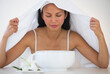 © Tetra Images/Tetra Images - Woman under towel having steam beauty treatment