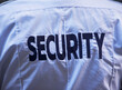 © fotog/Tetra Images - Back of security guard`s shirt
