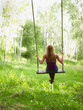 © John Kelly/Tetra Images - USA, Colorado, Mature woman swinging, rear view