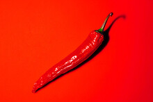 Red Chilli Pepper On Red Background
