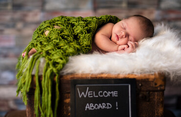 Wall Mural - newborn baby sleeping on suitcases