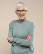 © Nikola - Senior female studio portrait. Short grey hair senior model. Fashion photography in studio. Old female wearing glasses. Confident senior female portrait.