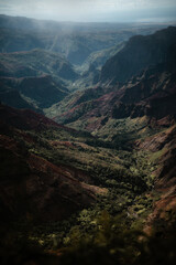 Poster - Vertical shot of rocky and foggy mountains under cloudy  sky