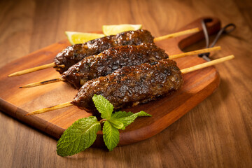 Beef kafta on the wooden board. Kafta, Traditional Arabic cuisine.