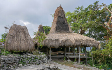 Wall Mural - Landscape view of traditional thatched roof house on stilts in Tarung Waitabar village, Waikabubak, West Sumba island, East Nusa Tenggara, Indonesia