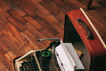 Fototapete - vintage typewriter with white paper stands on the floor indoors
