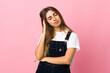 © luismolinero - Young woman over isolated pink background with headache