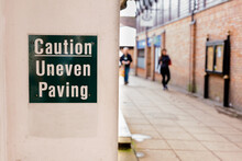 Caution Uneven Paving Sign In A Town Center
