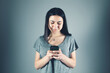 © Artvibe - a young girl holding a phone in her hands