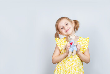 little caucasian girl with teddy bear looking at the camera