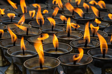 Full Frame Shot Of Lit Candles In Temple