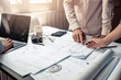 © amnaj - Architect man cooperation In working together at the office.