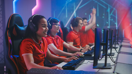 Wall Mural - Diverse Esport Team of Pro Gamers Wearing Headsets Play in Video Game on a Championship, Win and Celebrate with Clapping. Cyber Games Online Streaming Tournament Arena.