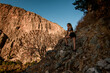 © fesenko - beautiful view of woman standing on rocky trail among mountains in Turkey