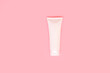 White plastic cosmetic package tube for medicine or cosmetics cream, gel, skin care, toothpaste, packaging mockup with clipping path isolated on pink background. Template for design