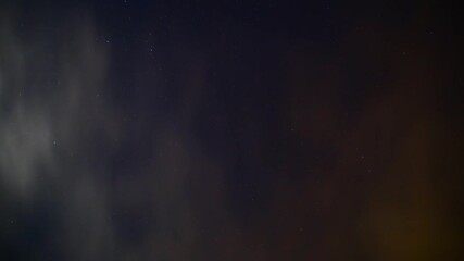Wall Mural - quickly moving clouds on starry sky