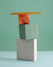 Close-up Of Stone Stack On Table Against Colored Background