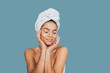 © progressman - Beautiful young woman in bath towel apply face cream