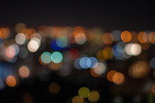 Defocused Image Of Illuminated Lights At Night