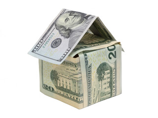 Denominations of USA dollar bills are arranged to represent a small house.