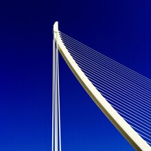 Low Angle View Of White Bridge Against Blue Sky