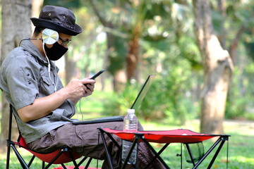 Poster - man using smartphone in garden background and business concept