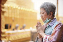 Old Asian Senior Woman Traveler Tourist Praying At Buddhist Temple.