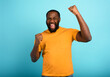 © alphaspirit - Boy wins something. Amazed and surprised expression face. Light blue background