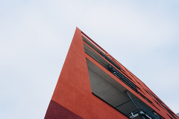 A fragment of a modern building with a geometric shape against a blue sky.Urban abstract futuristic architecture in the style of minimalism creates a geometric stylish pattern.Vertical orientation