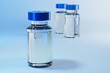 Vaccine bottle with blue cap on blue background