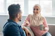 © Prostock-studio - Cheerful lady in hijab having conversation with her husband